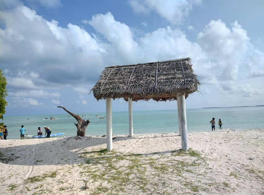 How can visitors enjoy the calm waters with activities like swimming, kayaking, and sailing?